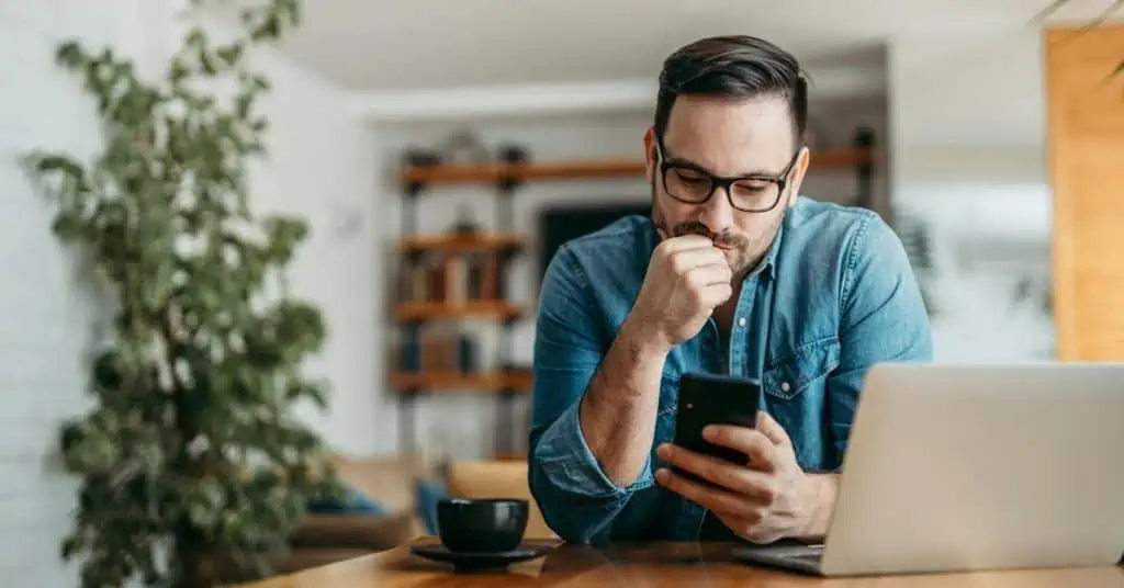 Pensive Man Checking His Smartphone