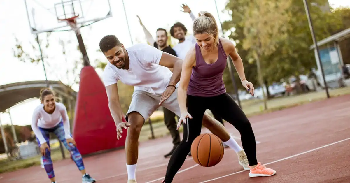 A Man and a Woman Playing Basketball