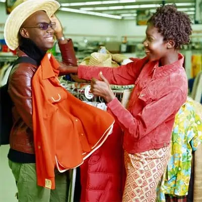 Young Black Man and Woman Having Fun Thrift Shopping