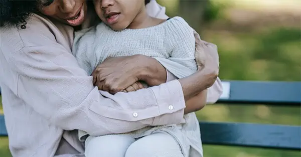 Mother Hugging Daughter Tightly