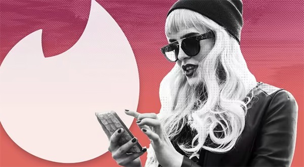 Woman Checking Her Mobile - Tinder Logo Background