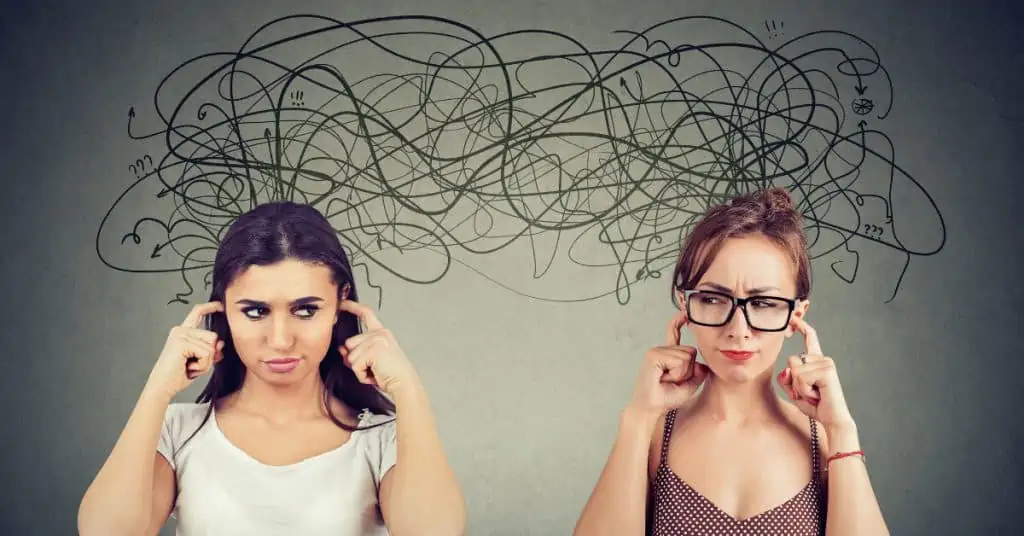 Women Covering Their Ears and Looking at Each Other