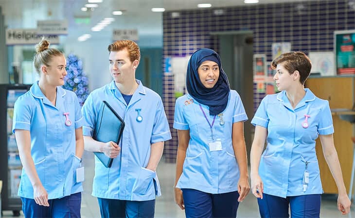 Group of Nurses Walking in a Hospital