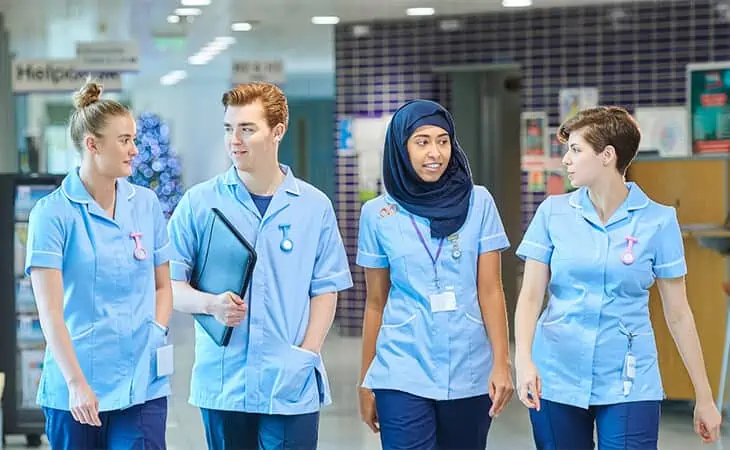 Group of Nurses Walking in a Hospital