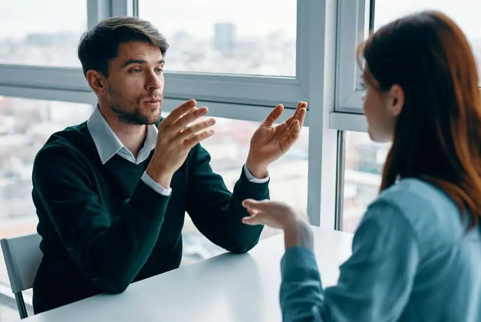 Man and woman sitting at a table and talking