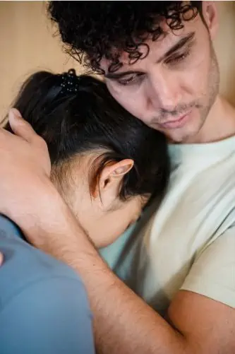 Man hugging woman