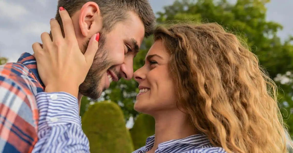 Man and woman face to face smiling at each other