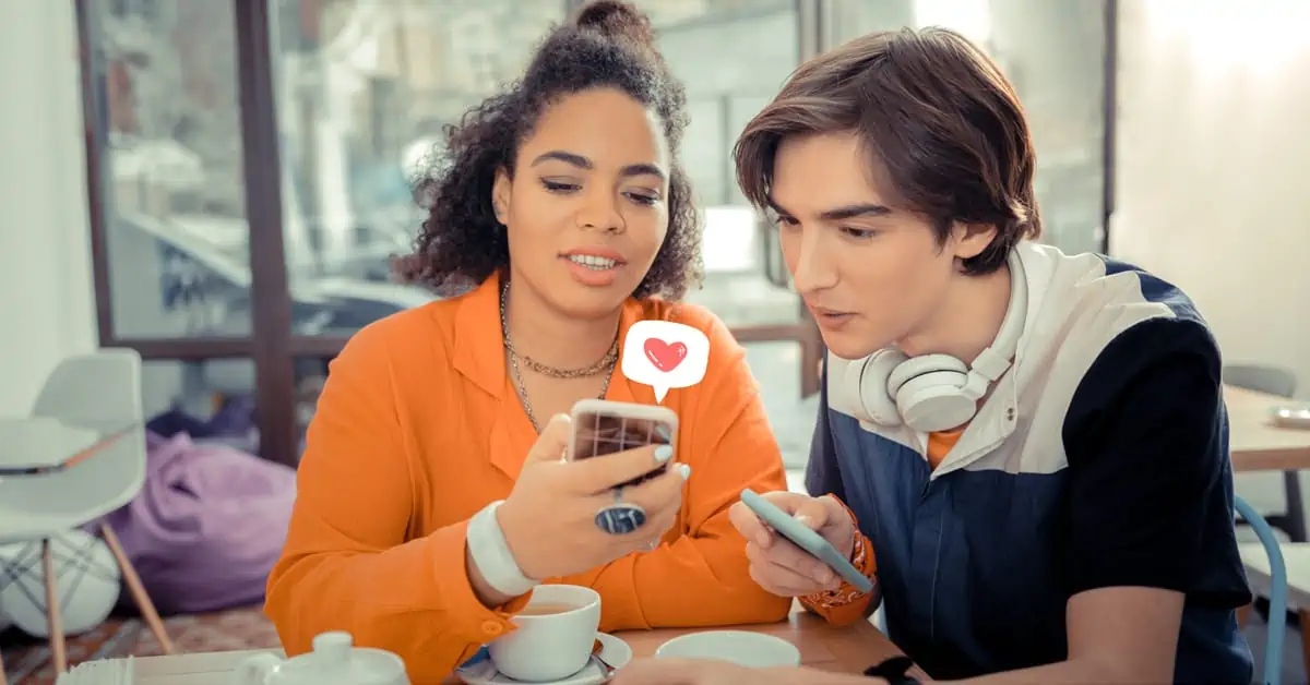 Young Woman Showing Something to Young Man - Smartphone