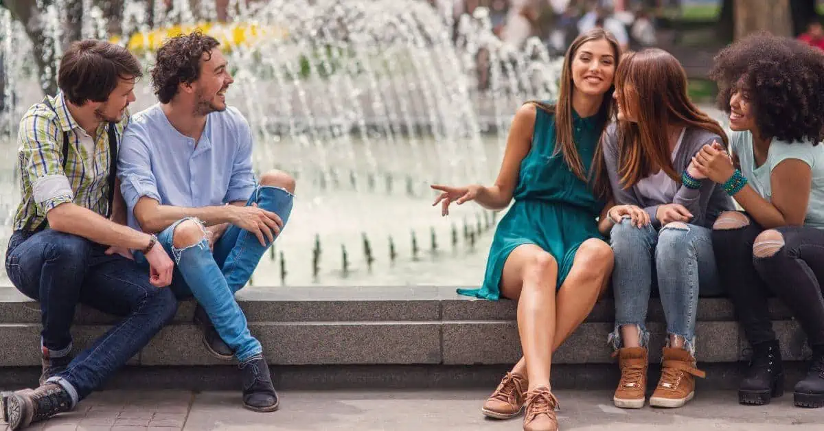 Two guys flirting with a group of women