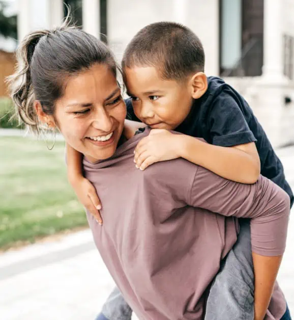 Woman Carrying Child on Her Back