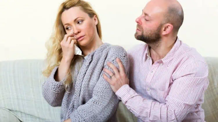 Man comforting upset woman