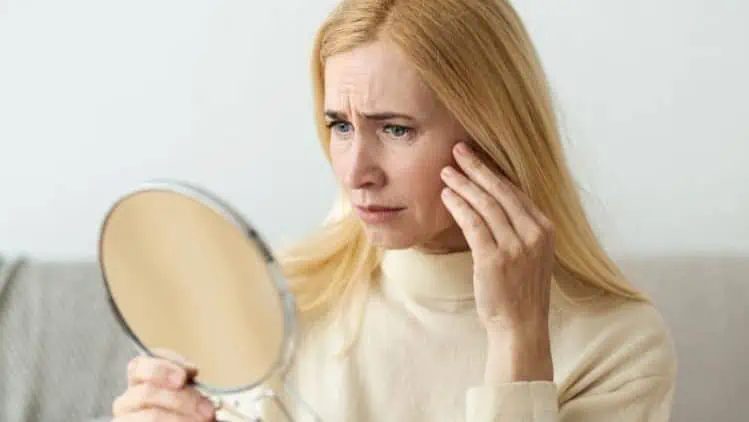 Woman Looking at Herself in Mirror