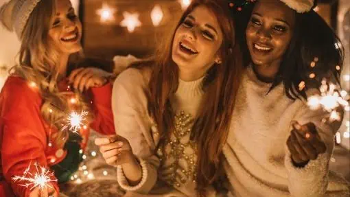 Three women celebrating New Years with a pajama party