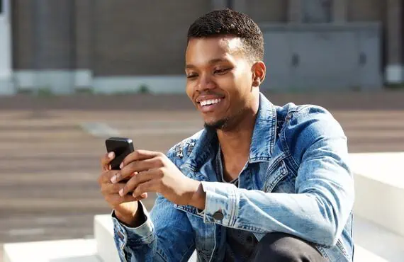 man smiling at text woman sent him