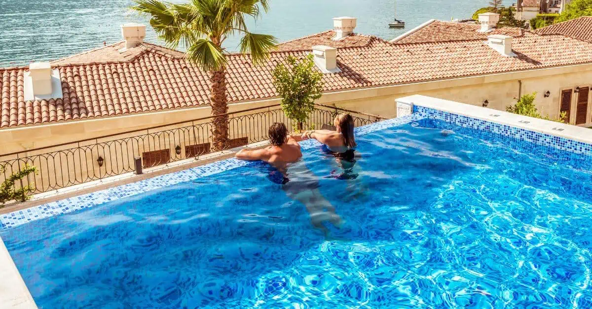 couple hanging out in an infinity pool