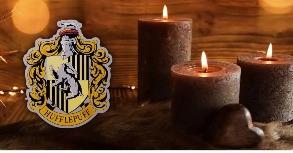 Hufflepuff symbol and three brown candles