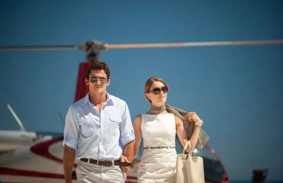 man and woman getting off of helicopter