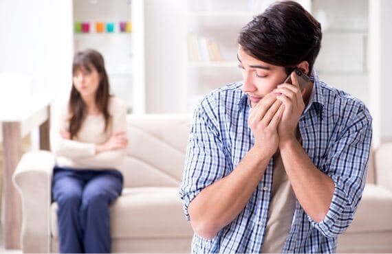 man on phone with another woman while on date