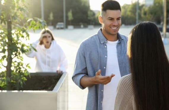 Woman watching guy with another girl