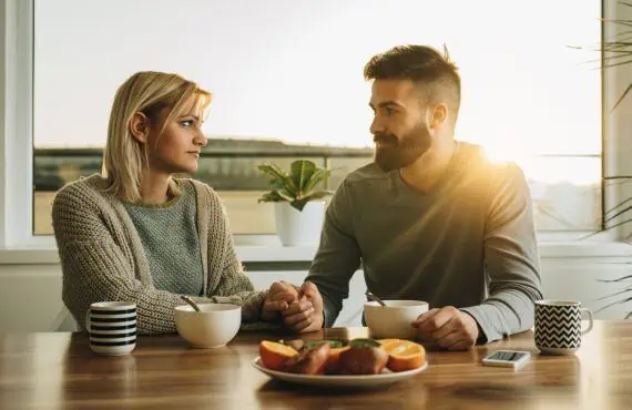 couple talking at dining room table