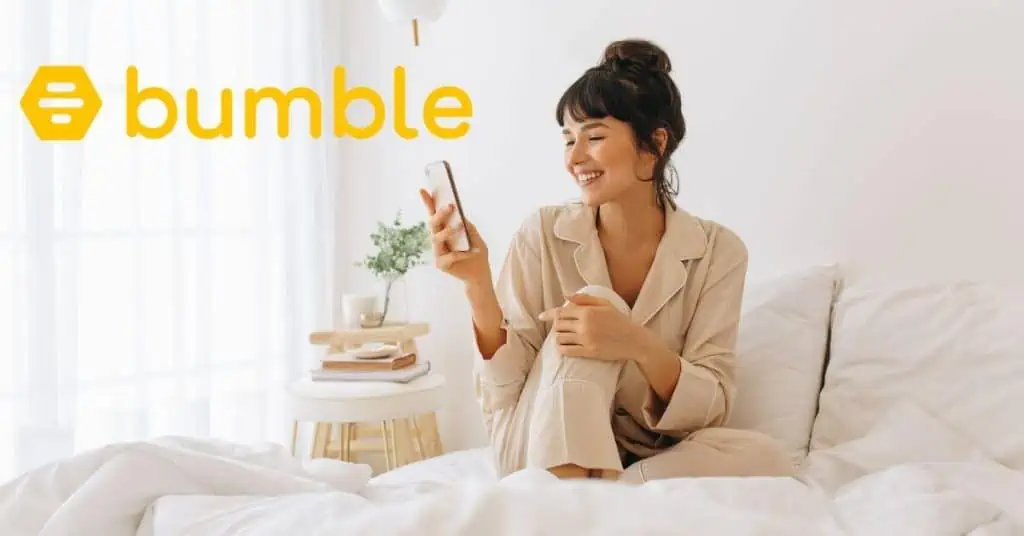 Woman sitting in bed using Bumble app