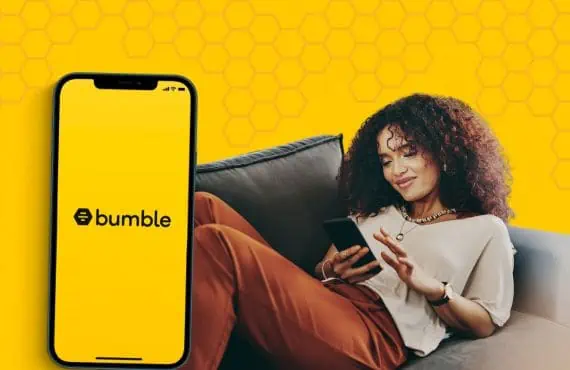 woman using bumble app on couch