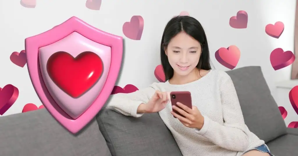 woman sitting on couch looking at phone with pink shield and heart beside it and hearts in the background