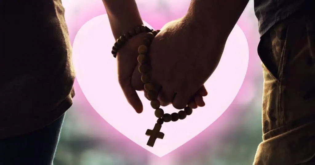 christian couple holding hands and cross necklace