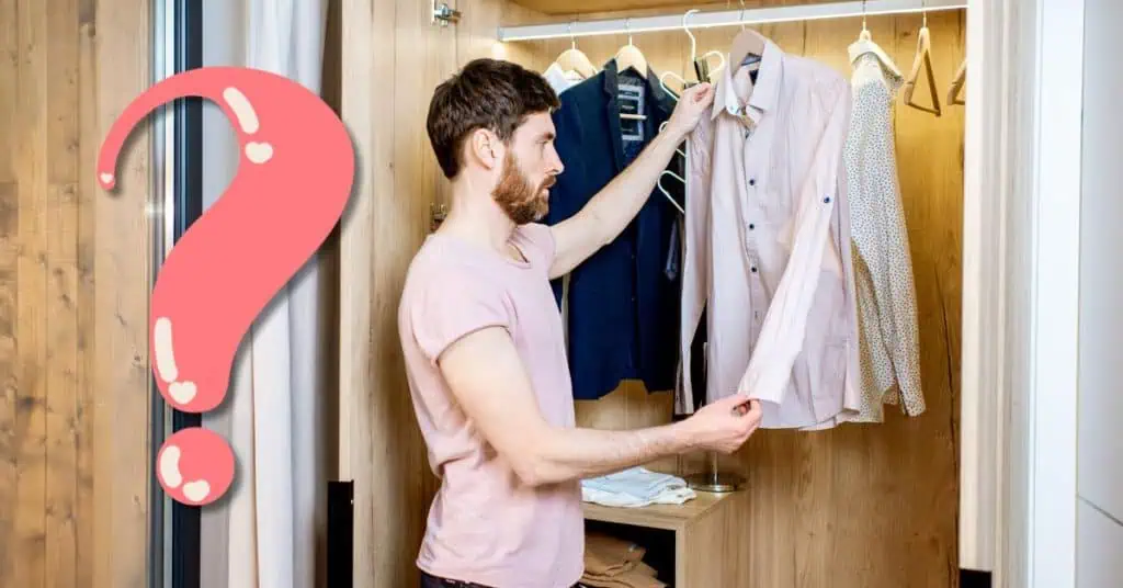 man looking at clothes in closet with question mark next to him